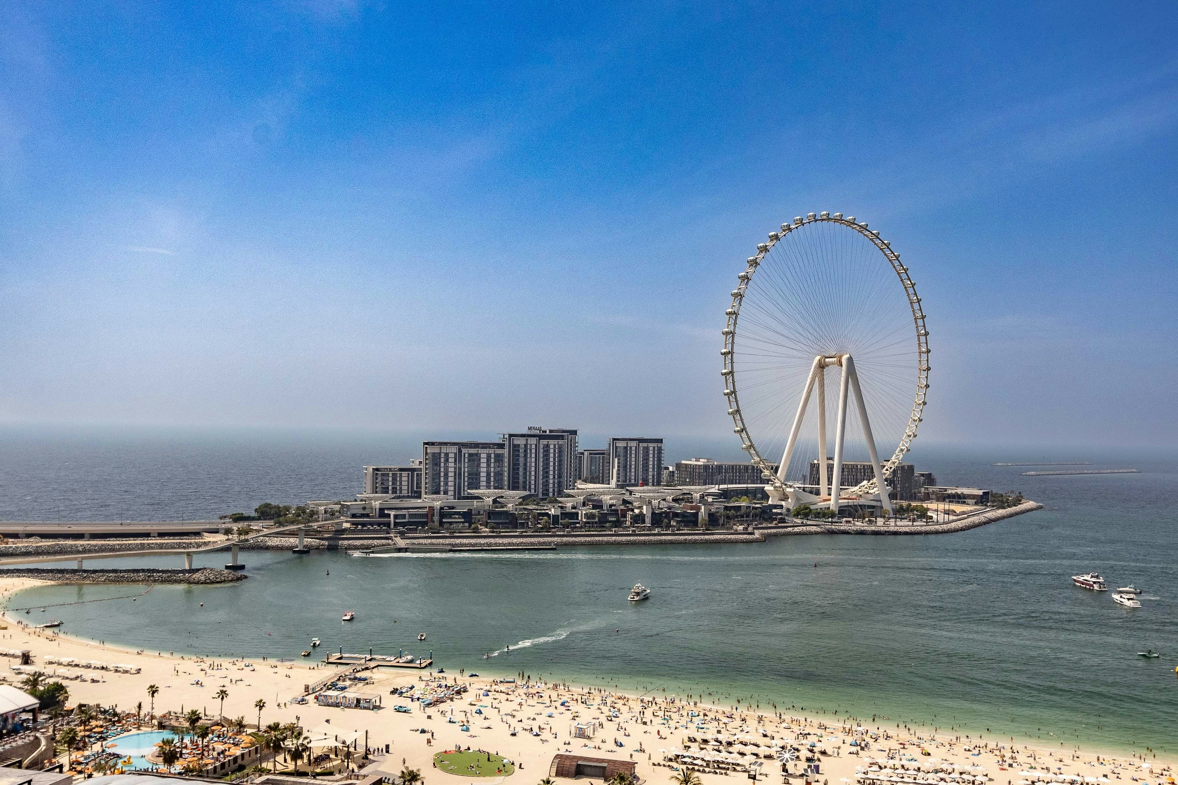Bluewaters Island and the Ain Dubai wheel seen across the water from above JBR Beach