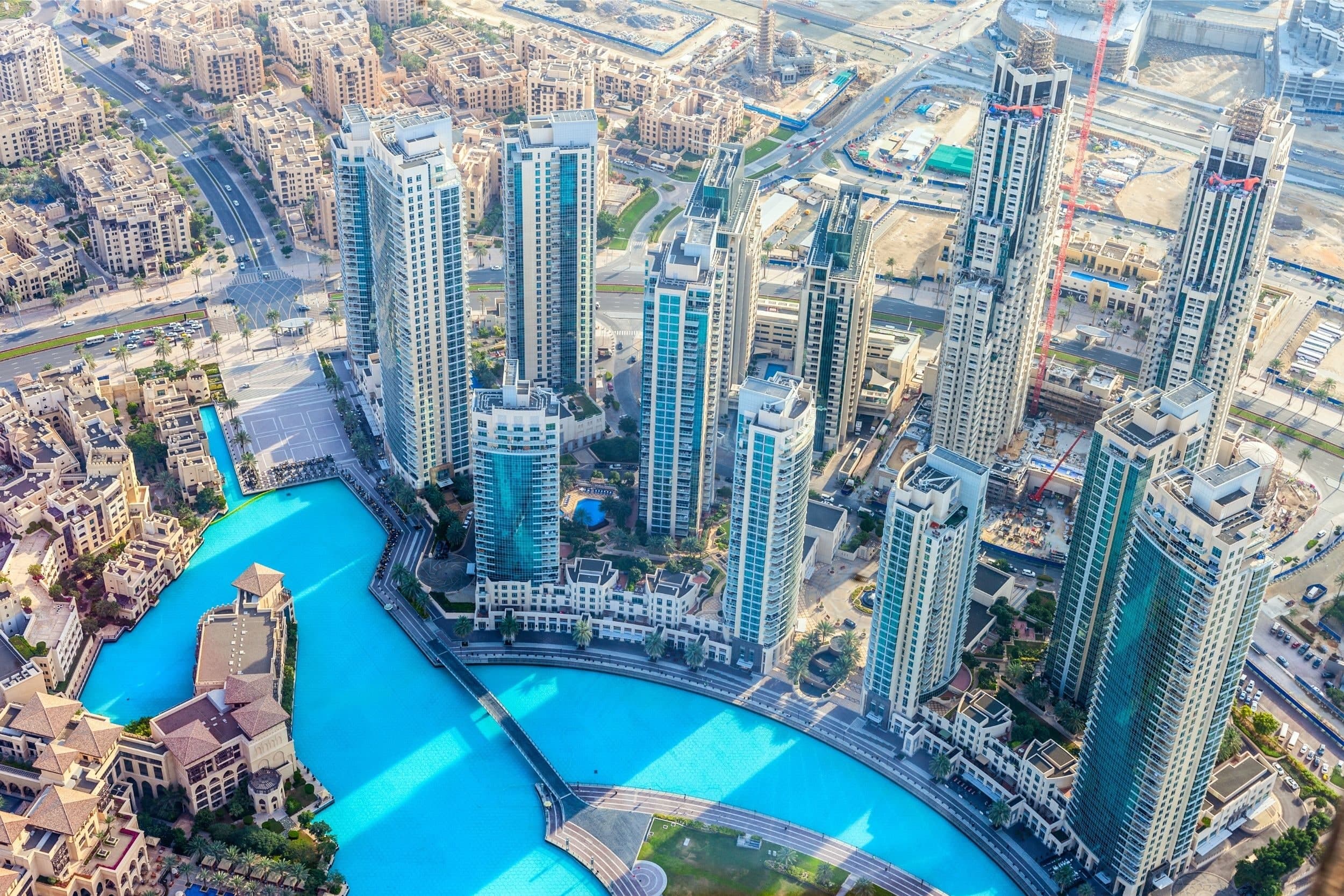 Burj Lake from the air, with the residential towers of Downtown Dubai along its shore and the low-rise buildings of Old Town on the left